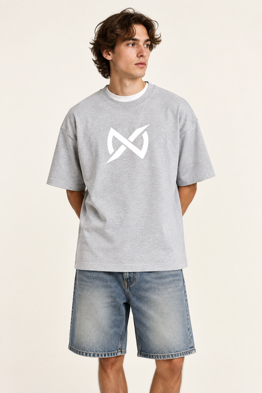 A light heather gray short-sleeve crewneck t-shirt featuring a white stylized infinity symbol printed on the center chest, displayed against a solid white background.